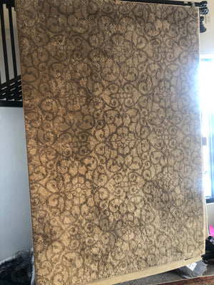 Tan and gray patterned area rug